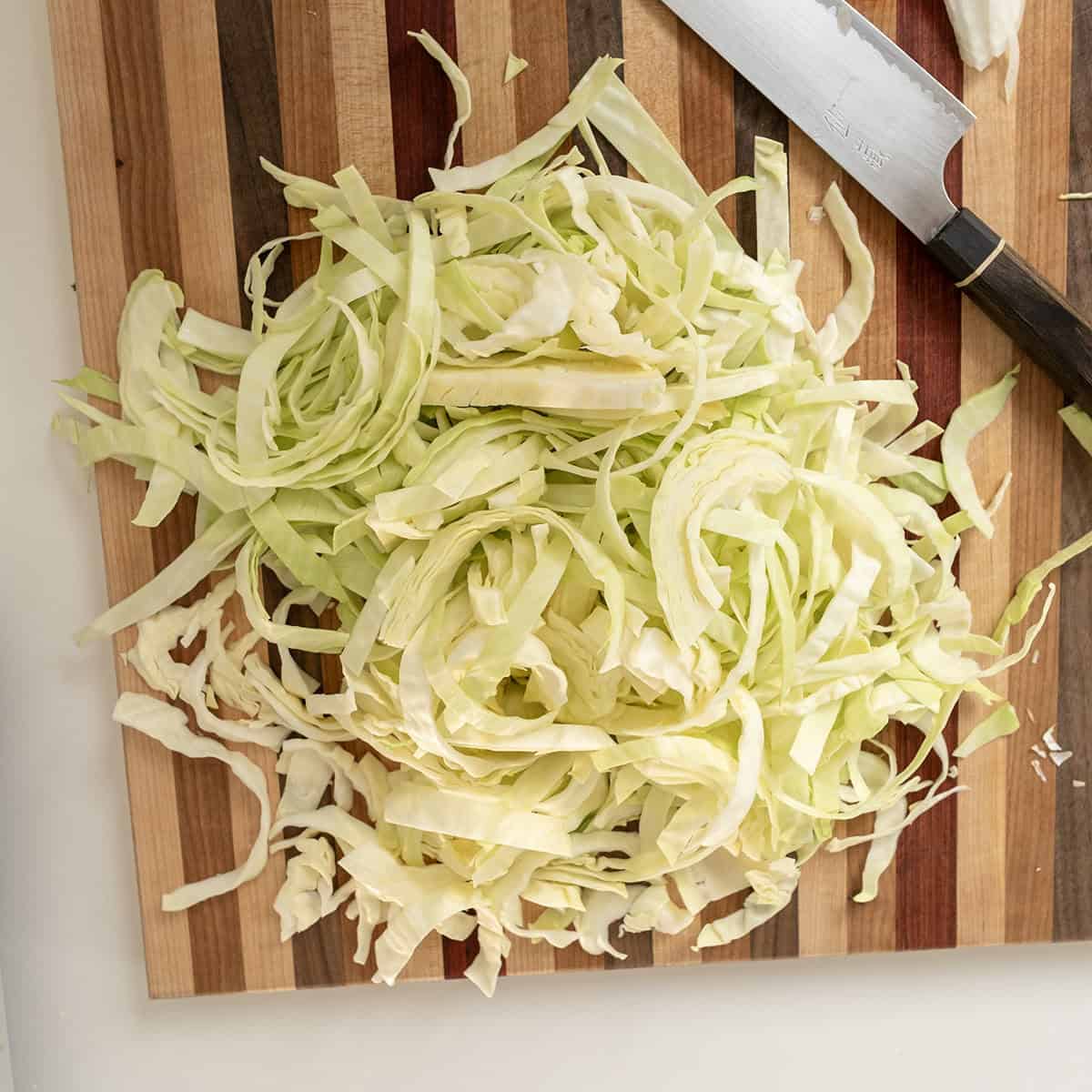 Sliced cabbage on a cutting board.