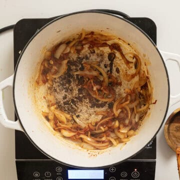 Caramelizing tomato paste with onions.