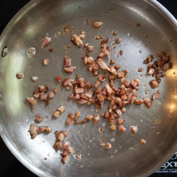 pancetta frying in a frying pan.