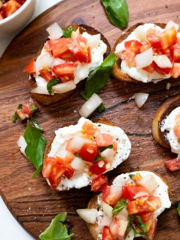 ricotta bruschetta toast with basil garnish