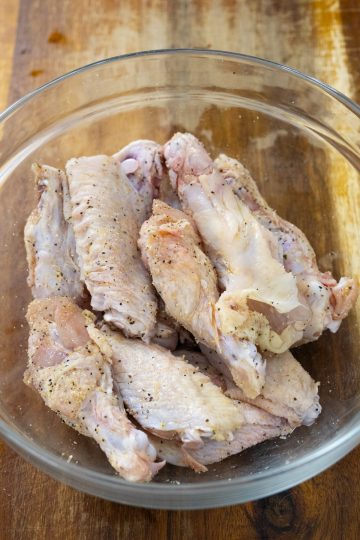 seasoning wings in a bowl