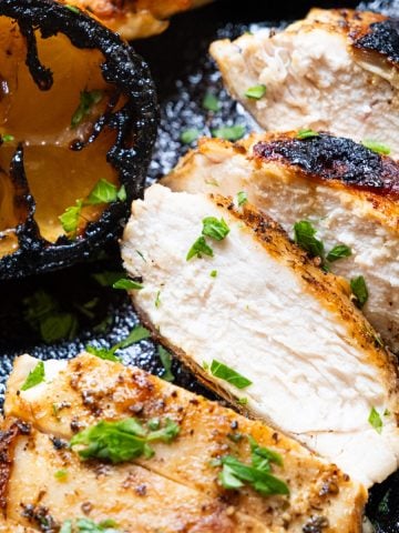 Chicken breast cooked in cast iron skillet and sliced.