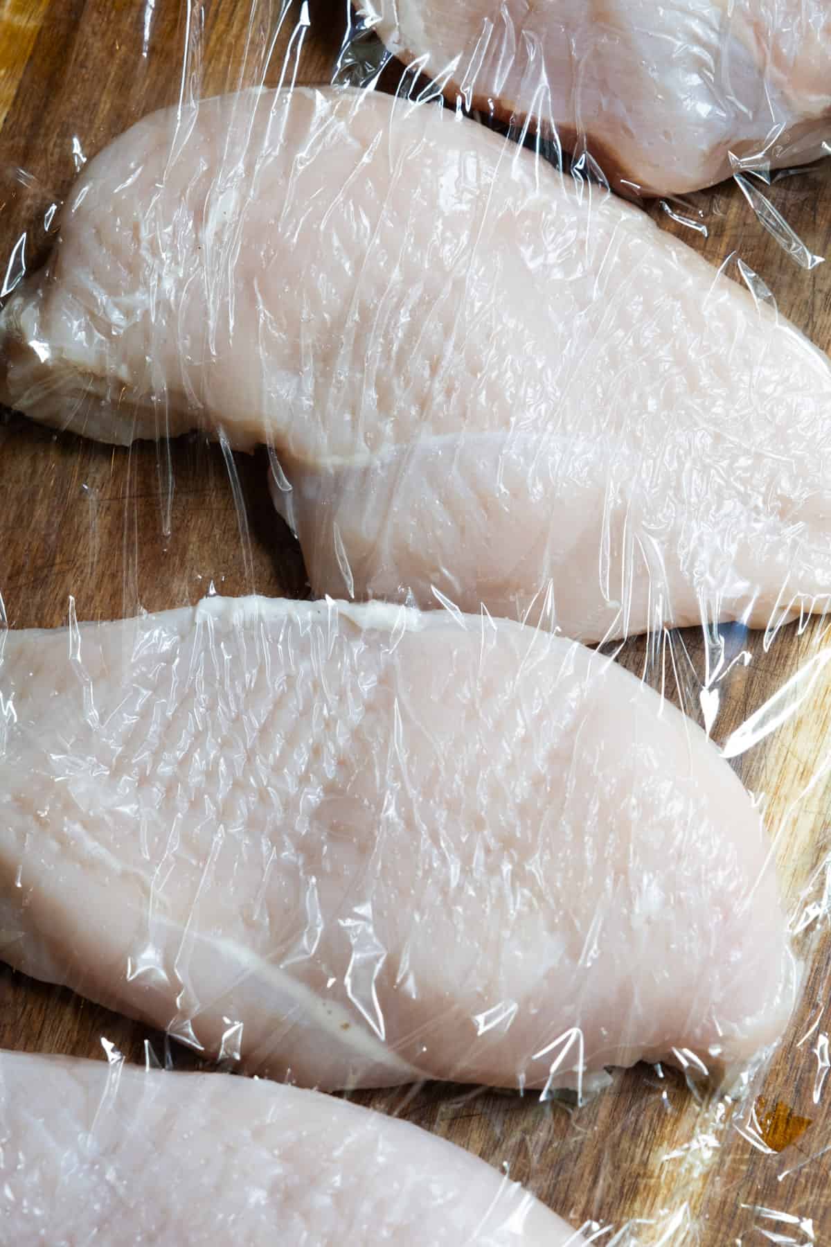 Tenderizing the chicken breast.