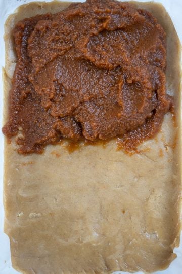 dough spread out with pumpkin butter on top