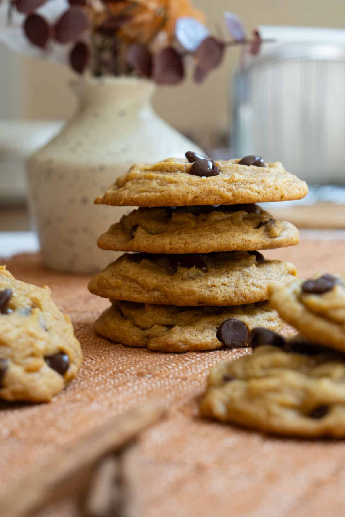 chewy pumpkin chocolate chip cookies stacked on top of each other