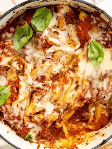 Italian stuffed shells with melted mozzarella in a dish.