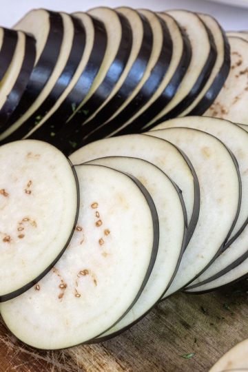 Eggplant sliced thinly for frying.