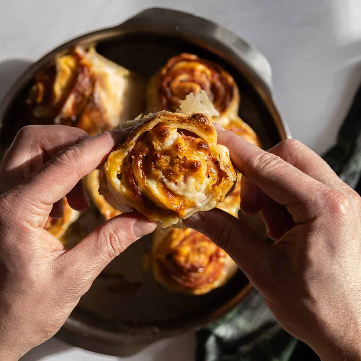 holding a pepperoni stromboli