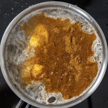 seasoning, lemon, beer and shrimp shells added to boiling water