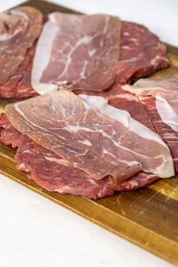 flank steaks topped with prosciutto
