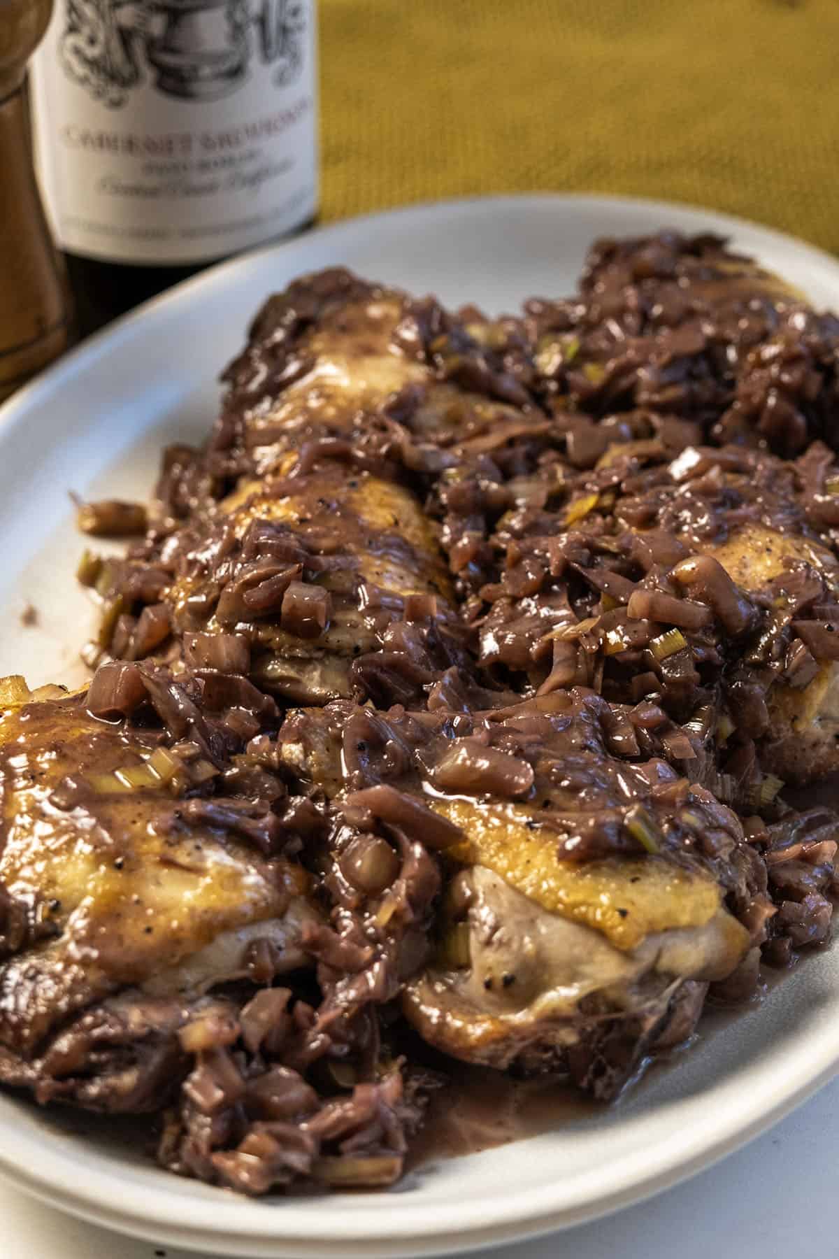 Chicken thighs covered in red wine and fennel sauce