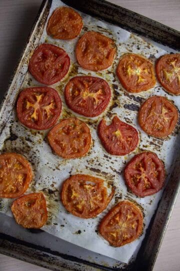 Roasted tomatoes on sheet pan with parchment