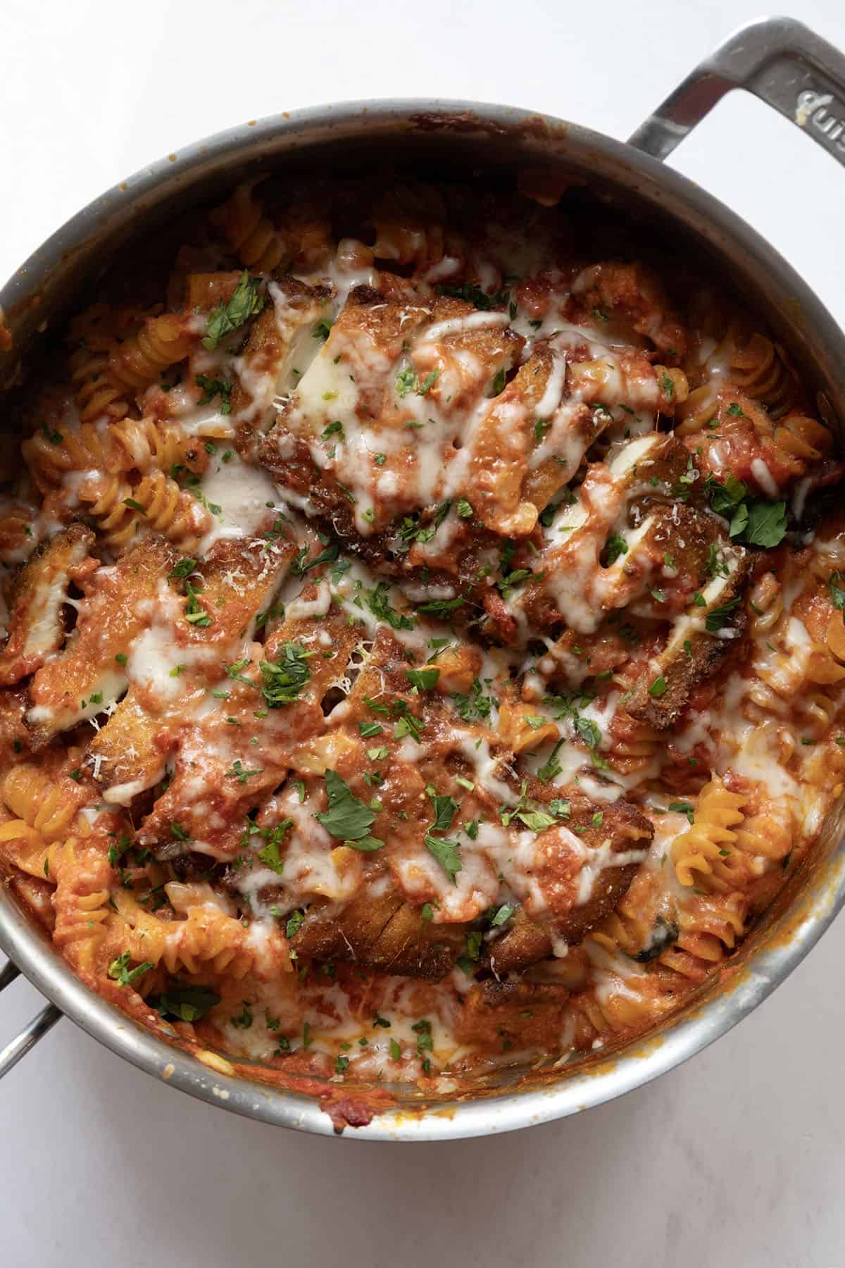 creamy chicken parmesan pasta in a skillet