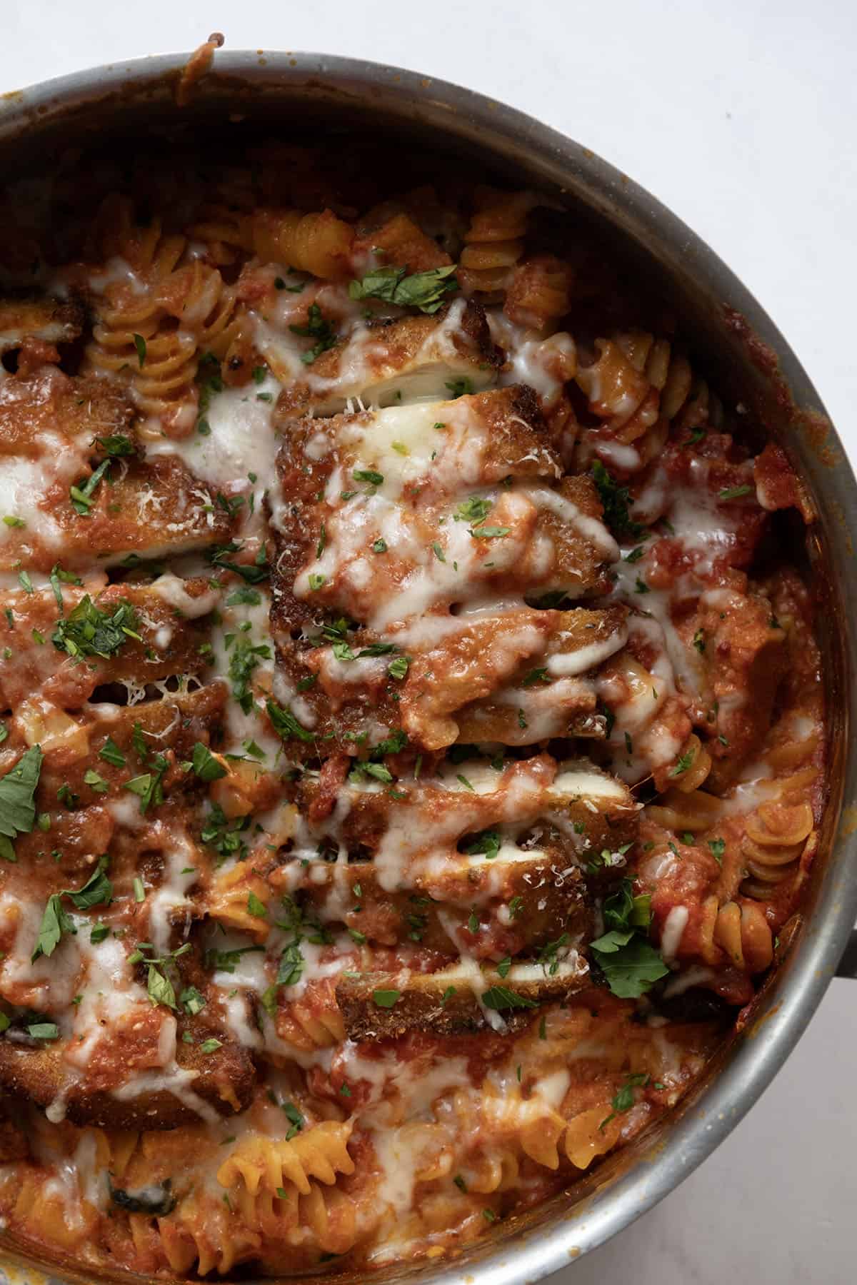 creamy chicken parmesan pasta in a skillet