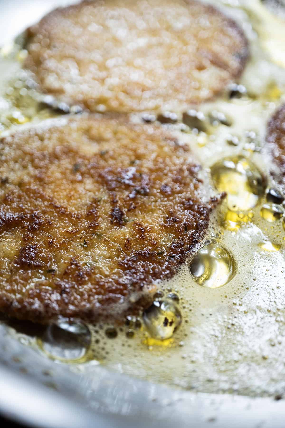 green tomatoes frying in olive oil