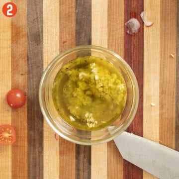 Whisking vinaigrette.