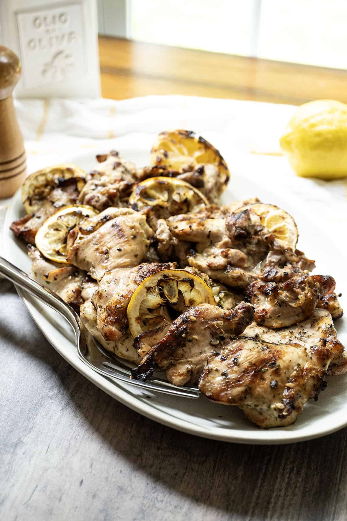 grilled lemon pepper chicken thighs served on a plate