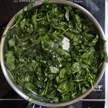 Spinach sauteing in the saucepan.