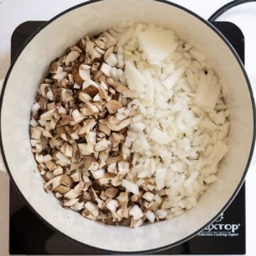 Mushrooms and onions in a dutch oven.