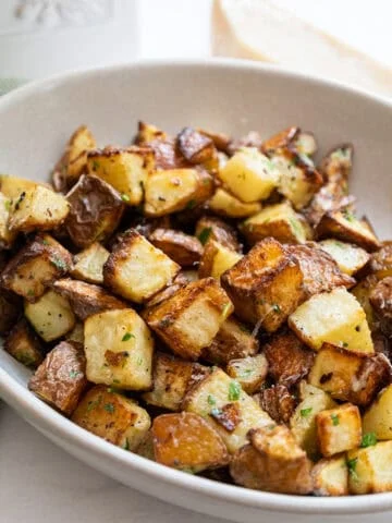 garlic parmesan potatoes in a bowl.
