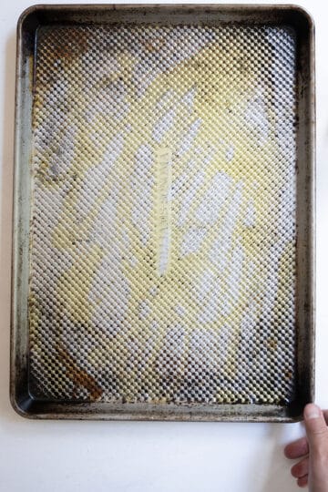Layer of olive oil on a baking tray.