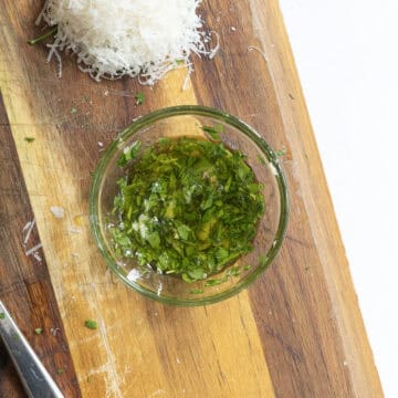 Garlic, parsley, and olive oil in a small bowl.