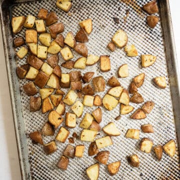 Potatoes roasted on a baking tray.