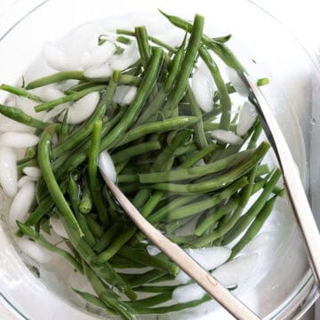Green beans in an ice water bath.