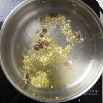 Garlic and anchovies sauteing in olive oil.