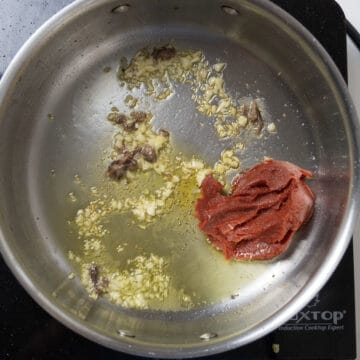 Tomato Paste caramelizing in saucepan.