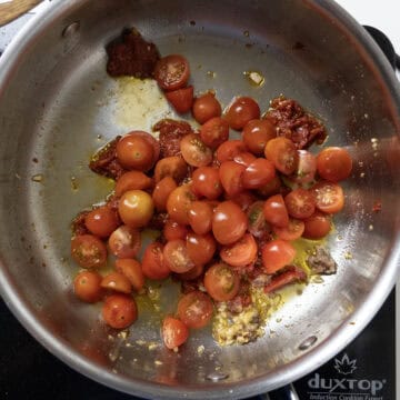 Cherry tomatoes added to the olive oil.