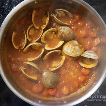 Clams opening in the sauce.