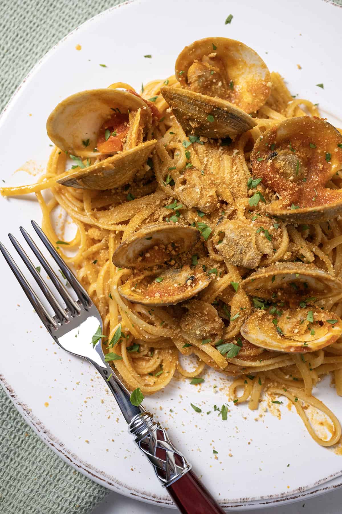 linguine with clams in red sauce on a plate.