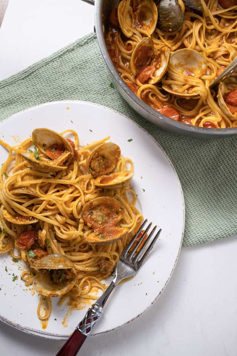 linguine with clams in red sauce on a plate.