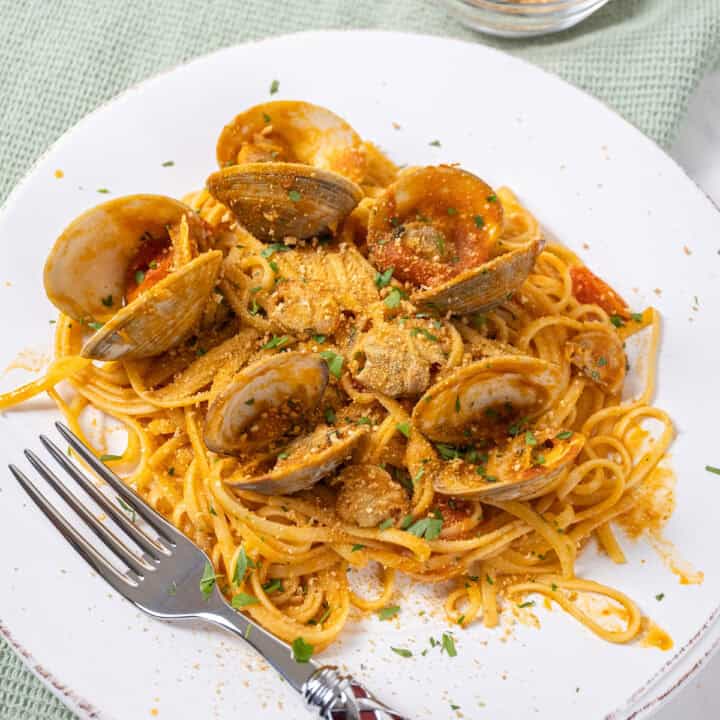 linguine with clams in red sauce on a plate.