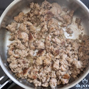 Sausage browned in a pan.