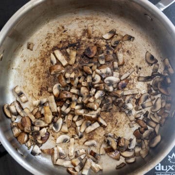 Mushrooms sauteing in pan.