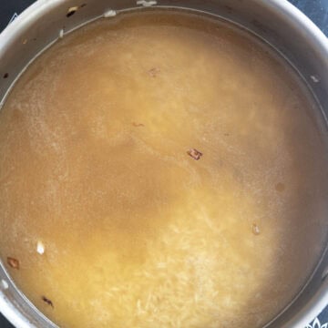 Simmering rice in chicken broth.