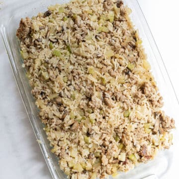Rice dressing spread out in a pyrex pan.