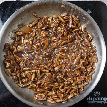 Simmering pecans in sauce.