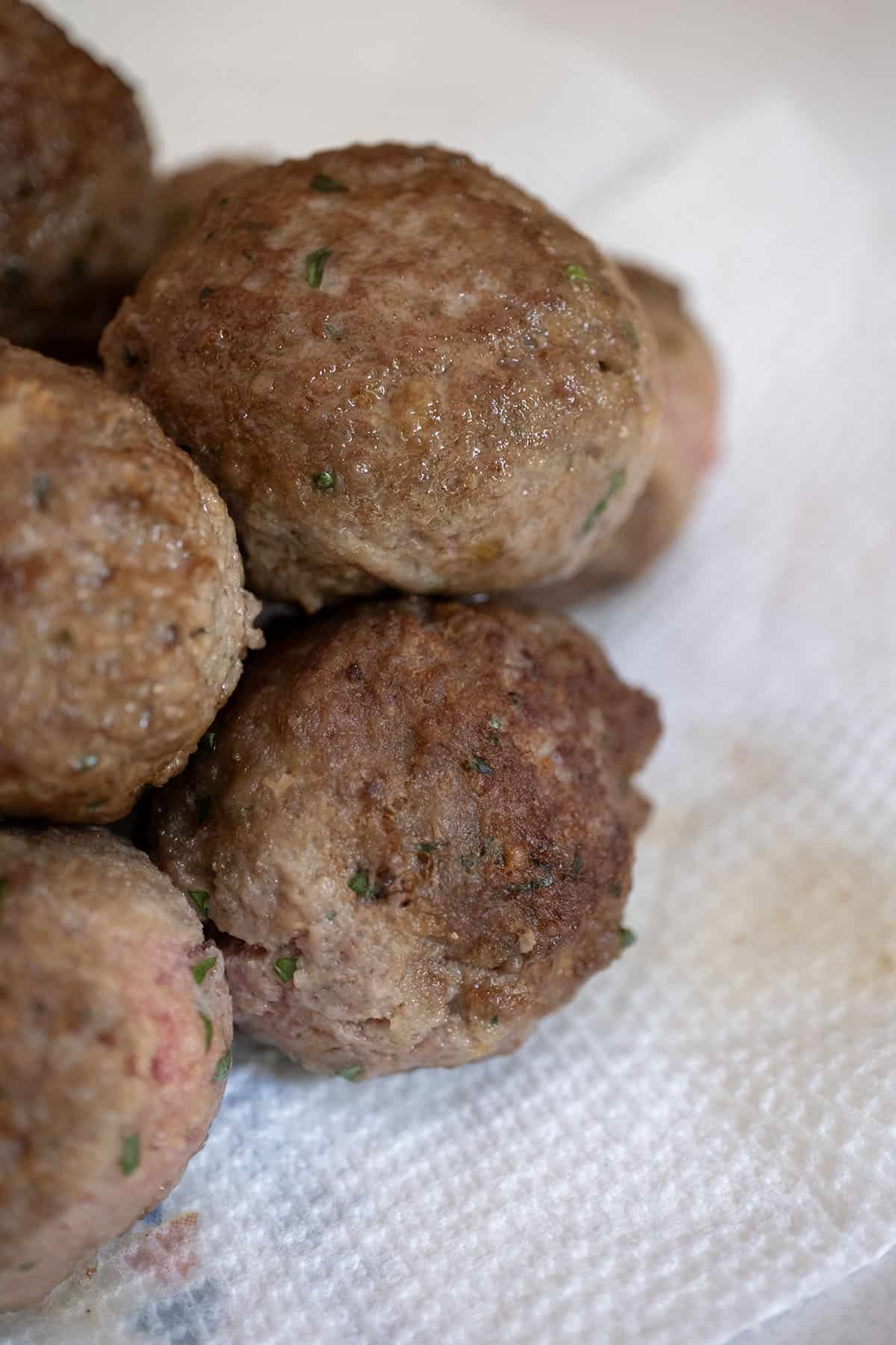 Pile of fried meatballs showing crispy texture.