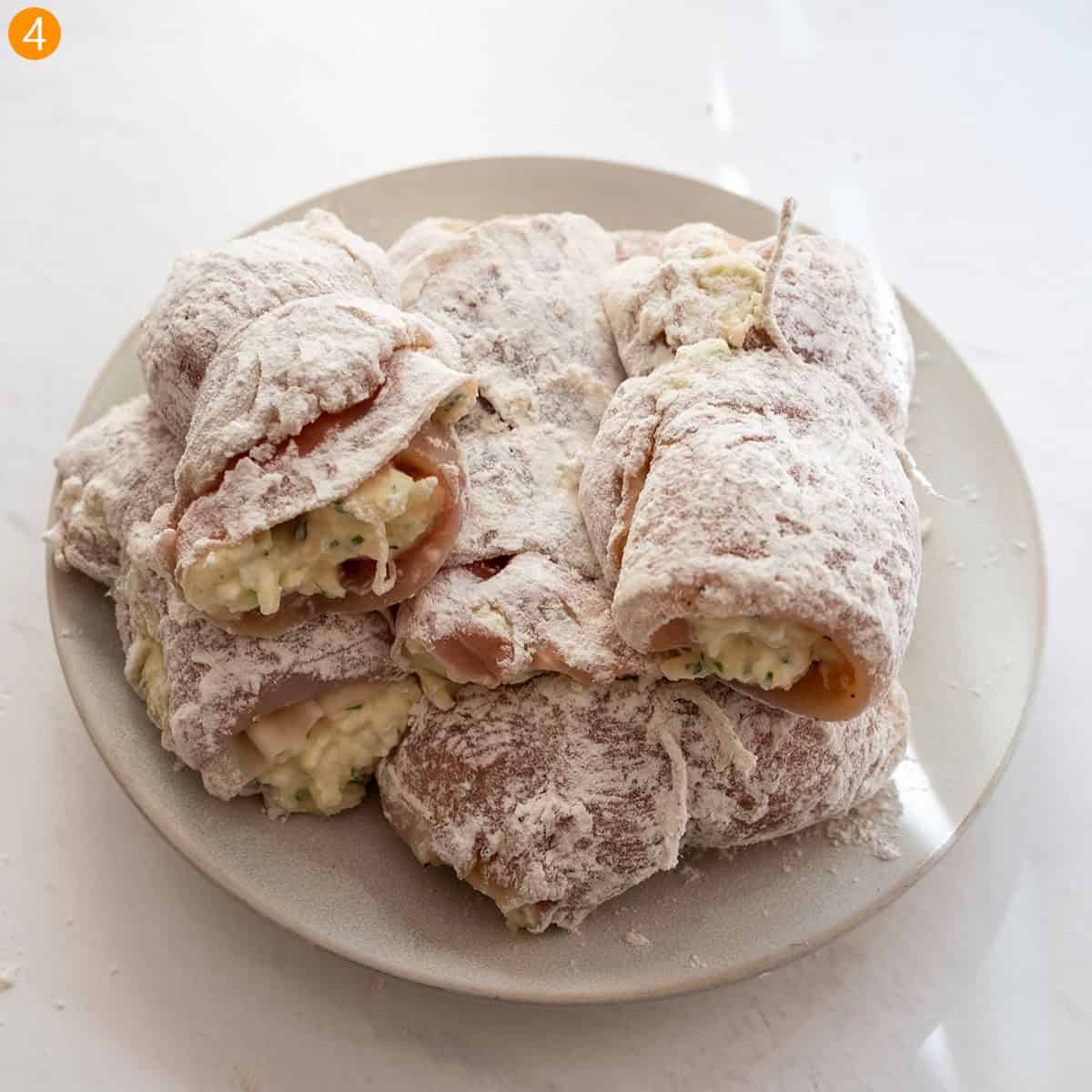 Dredge the chicken rollatini in flour.