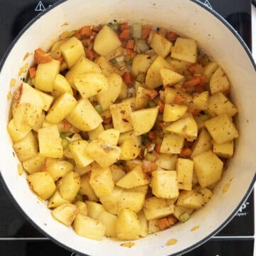 Potatoes added to the onion base with seasoning.