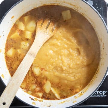 The blended half of the soup transferred back to the pot.