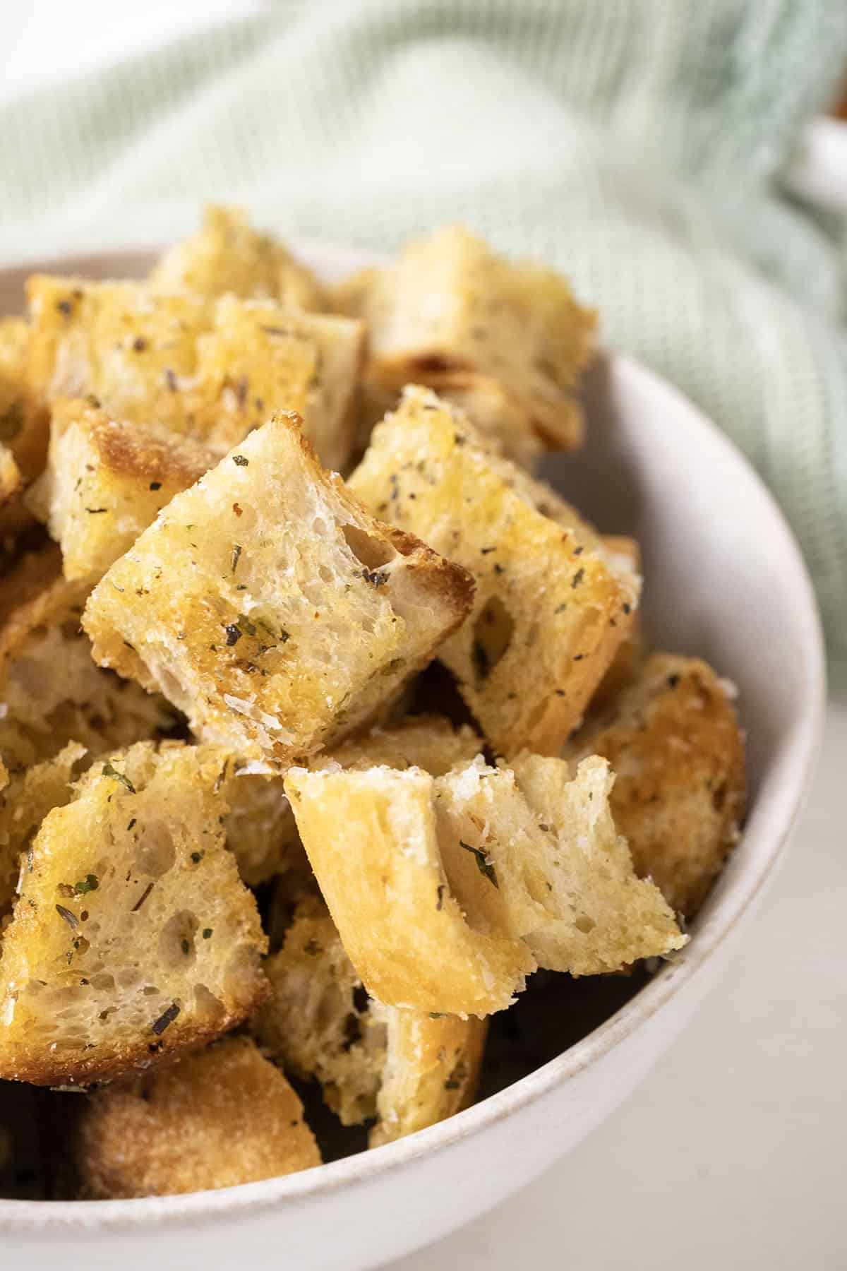 Parmesan seasoned croutons in a bowl.