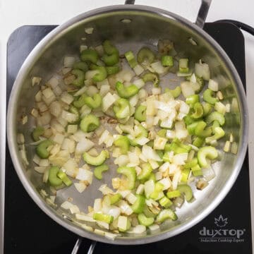 Sauteed celery and onion in a pan.