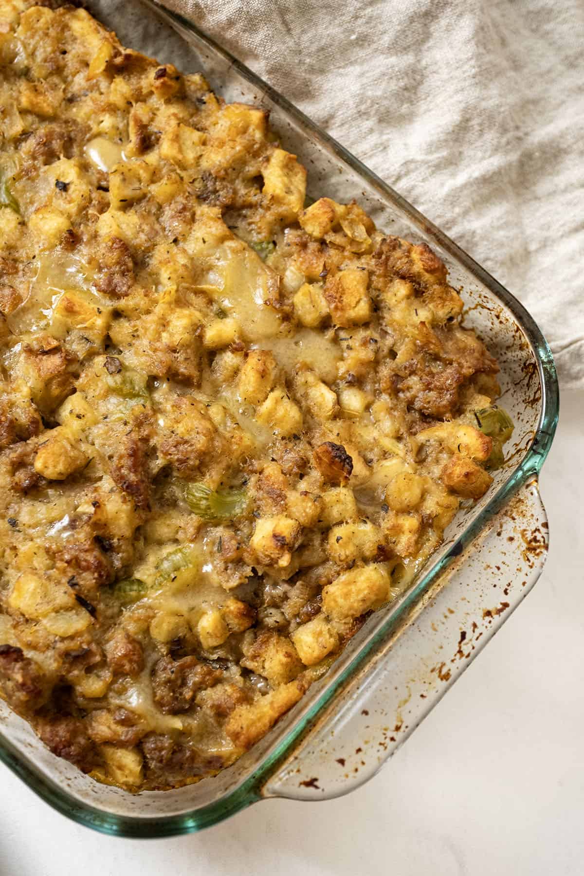 Italian sausage stuffing baked in a glass baking pan.