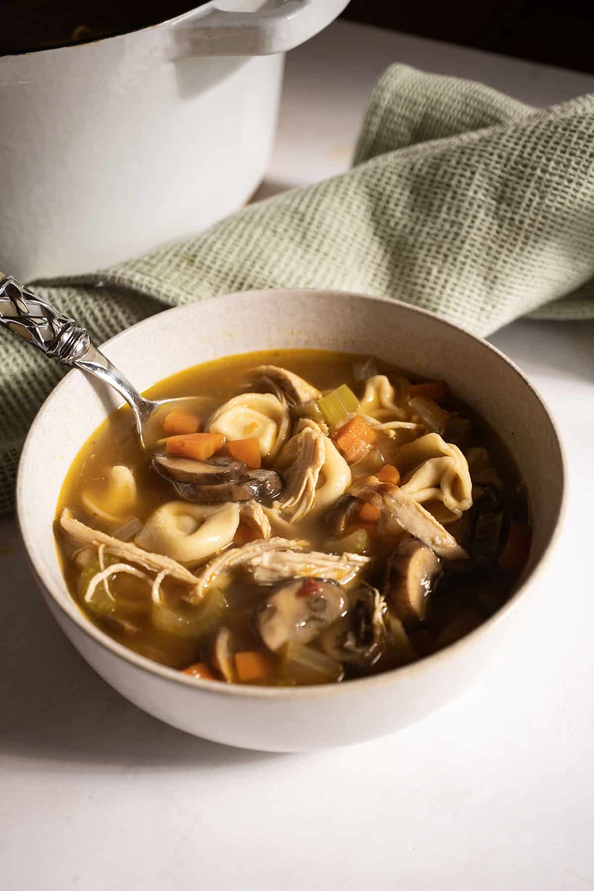 Chicken tortellini soup in a bowl.