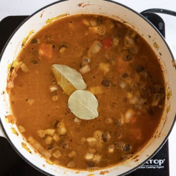 Broth and bay leaves in a pot.