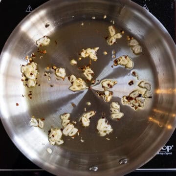 Garlic and crushed red pepper sauteing in olive oil.